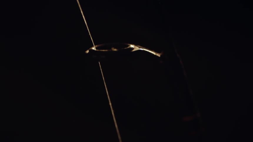 The fishing line lays on the hoop of the pole
