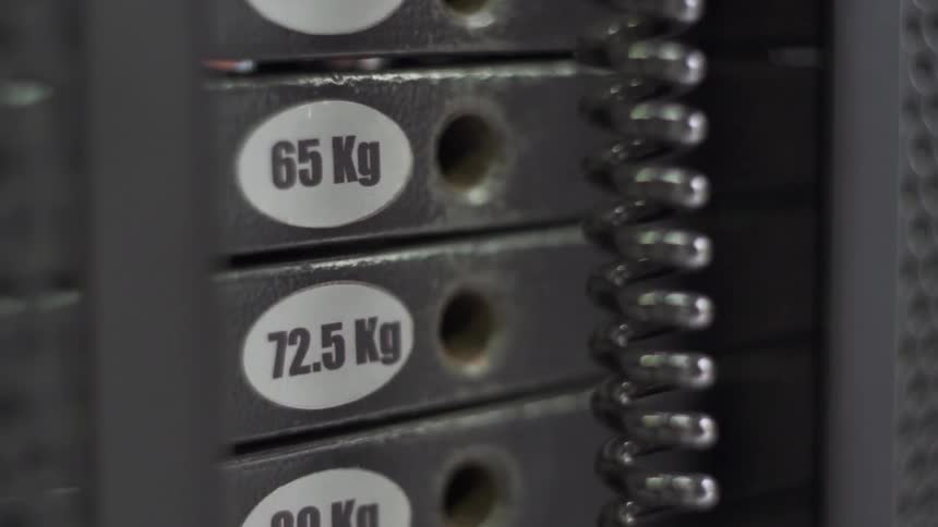 Someone lifting 125kg on a gym machine