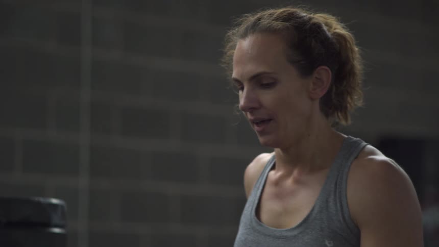 Woman talks over sits and puts her hand on her forehead