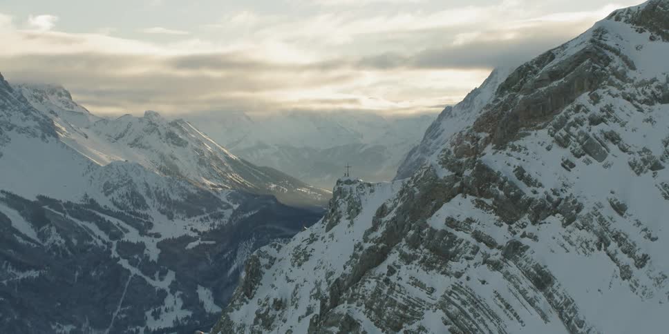Snow covered mountains on cloudy day