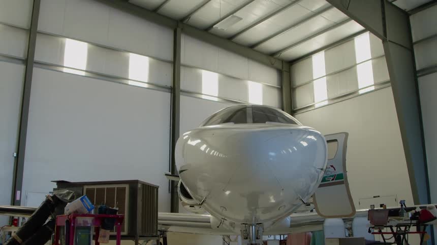 An airplane sits parked in a hangar