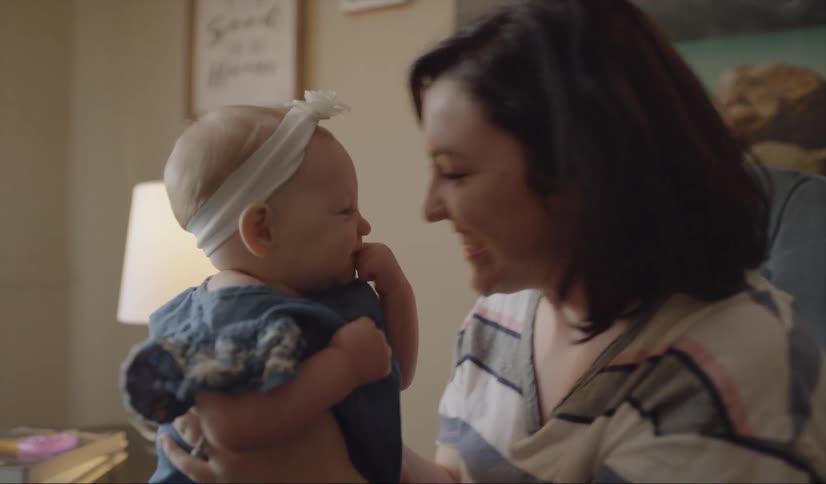 Mother plays with infant girl