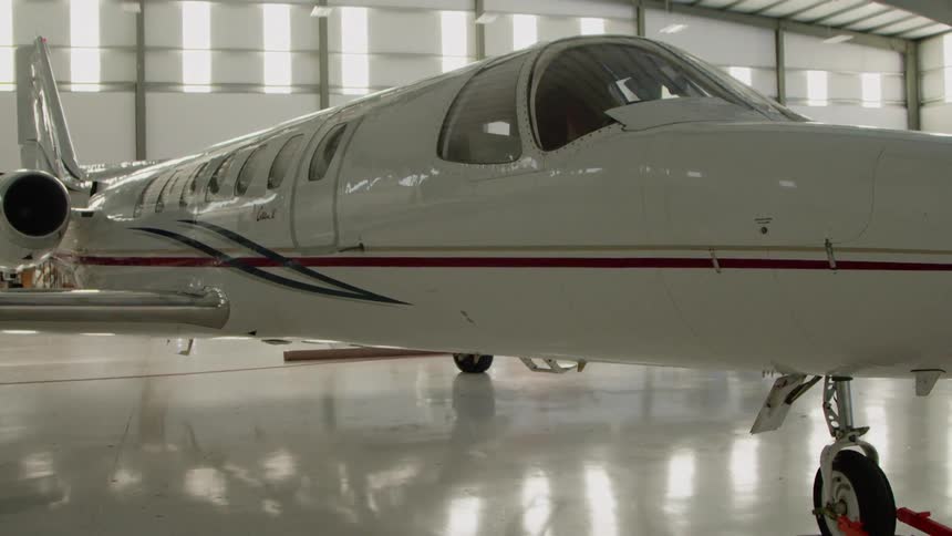 The white plane have a silver and red stripe on the side