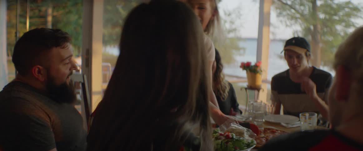 People talk and eat together at the table