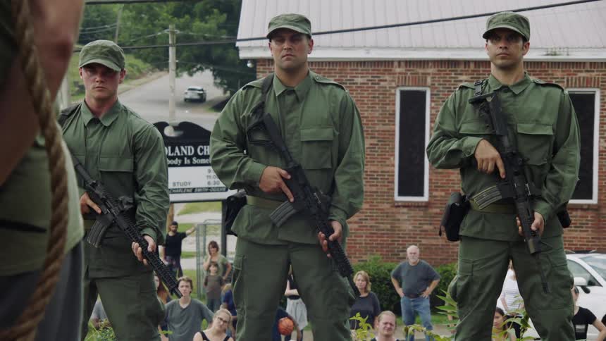 Soldiers turn around in unison and aim their guns