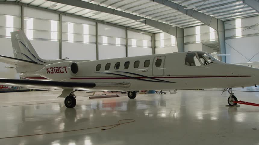 White airplane in a large airplane garage