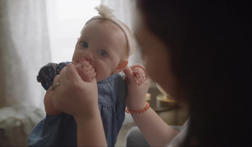 A woman holds a baby on her lap