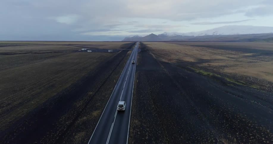 The cars travel down the long road