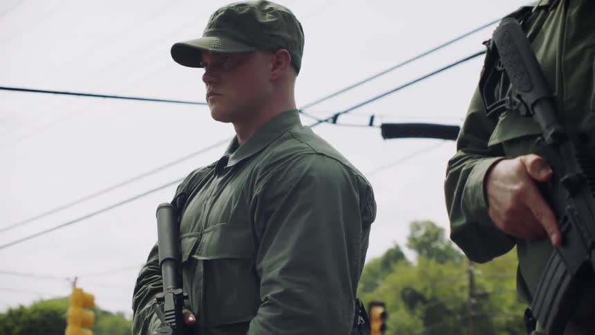 The soldiers lift their rifles together