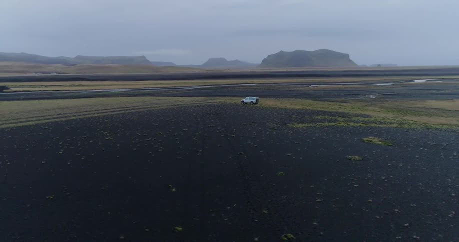 A truck is driving over the field