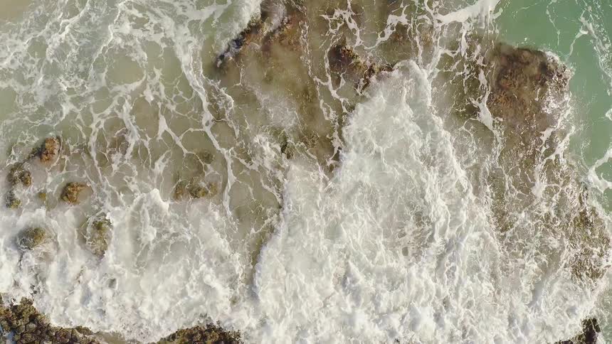 Waves crash onto the rocky shore