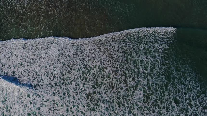 Ripples of water coming ashore as seen from directly above