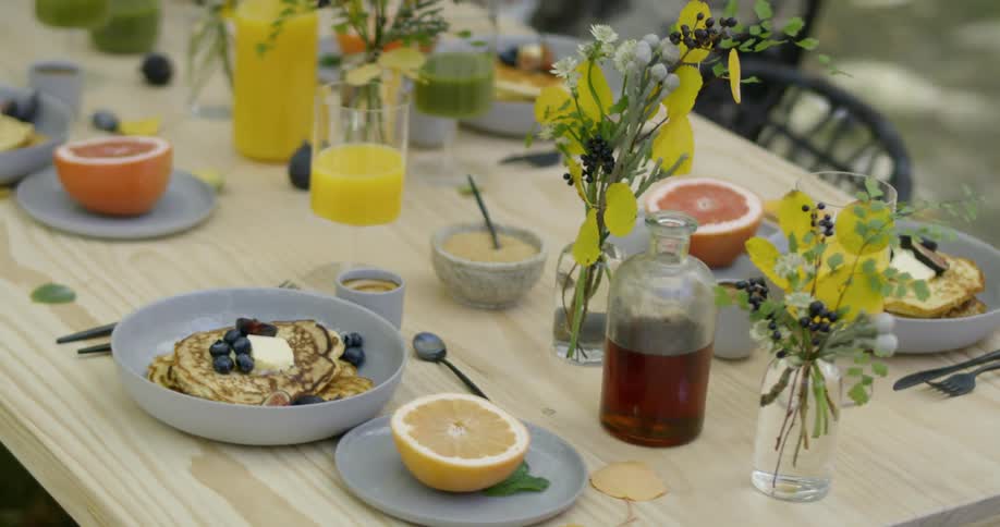 Breakfast food on a table outside on breezy day