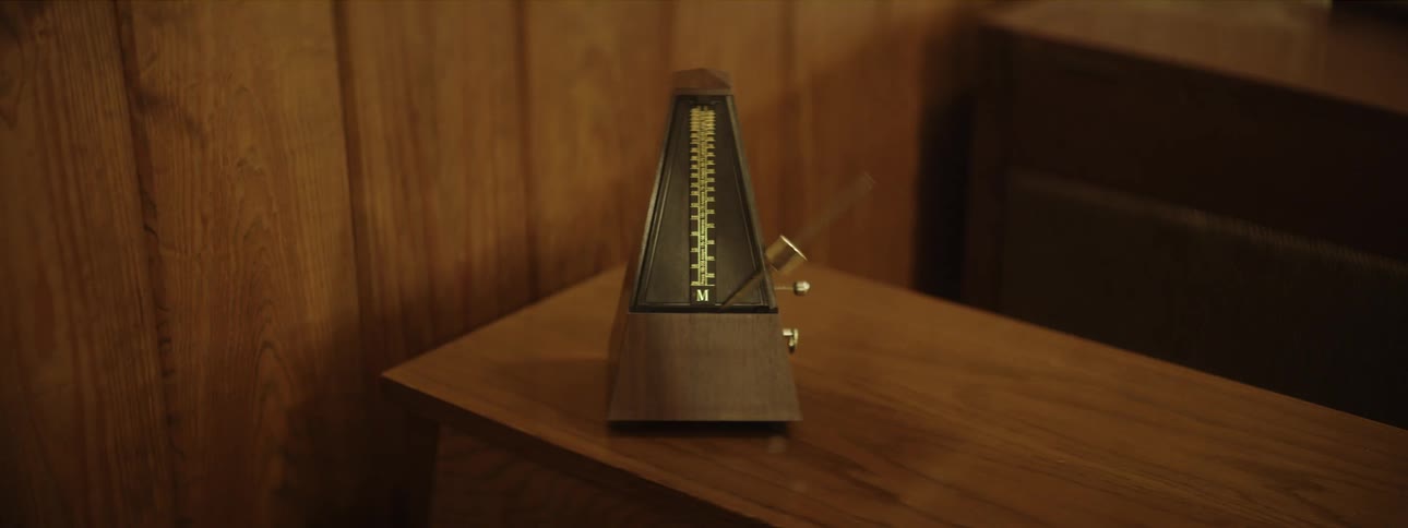 A metronome ticks back and forth