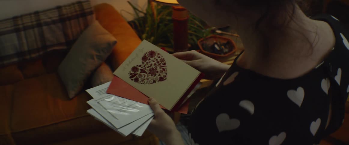 A woman reads a greeting card