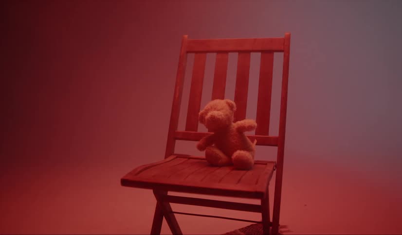 There is a teddy bear on the chair