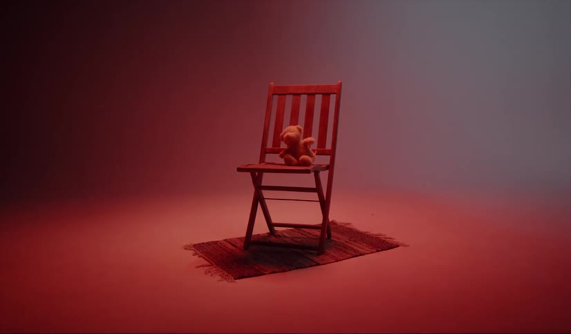 Teddy bear sitting in a wooden chair