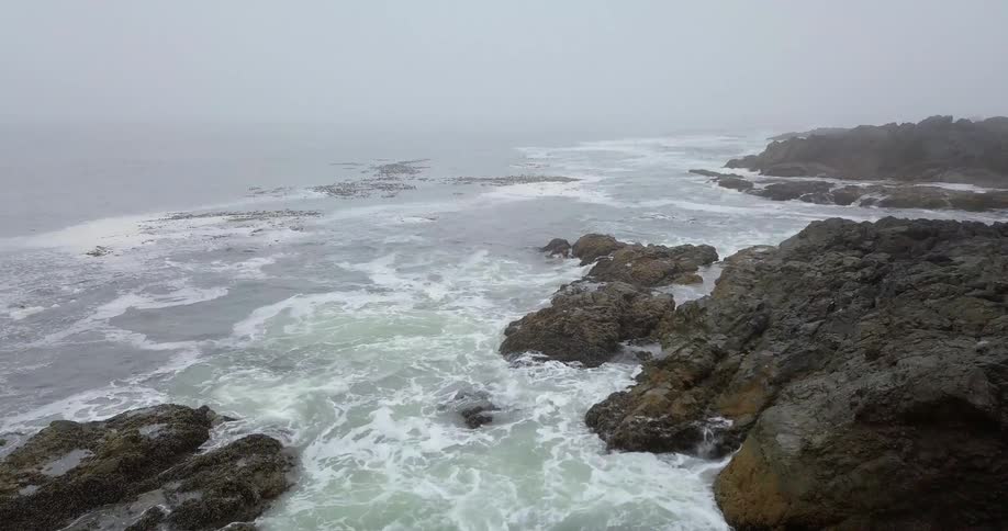 Water crashing up on rocks on shore