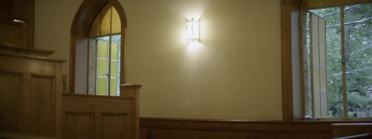 A bright lamp sits on the wall in the hall