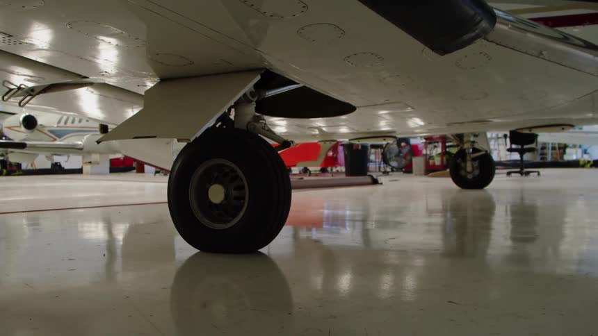 The plan is parked with other planes in the hangar