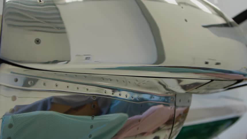 White airplane sits in a large building