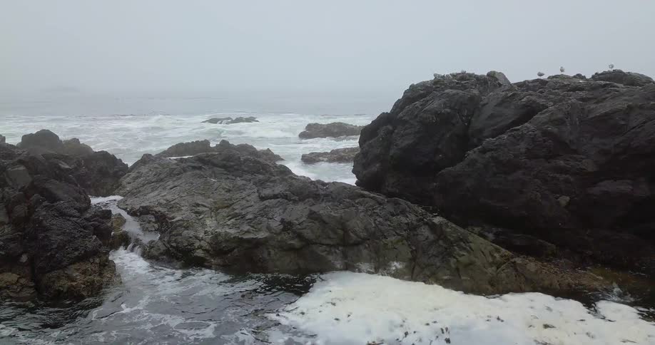 Water crashing up on rocks on shore