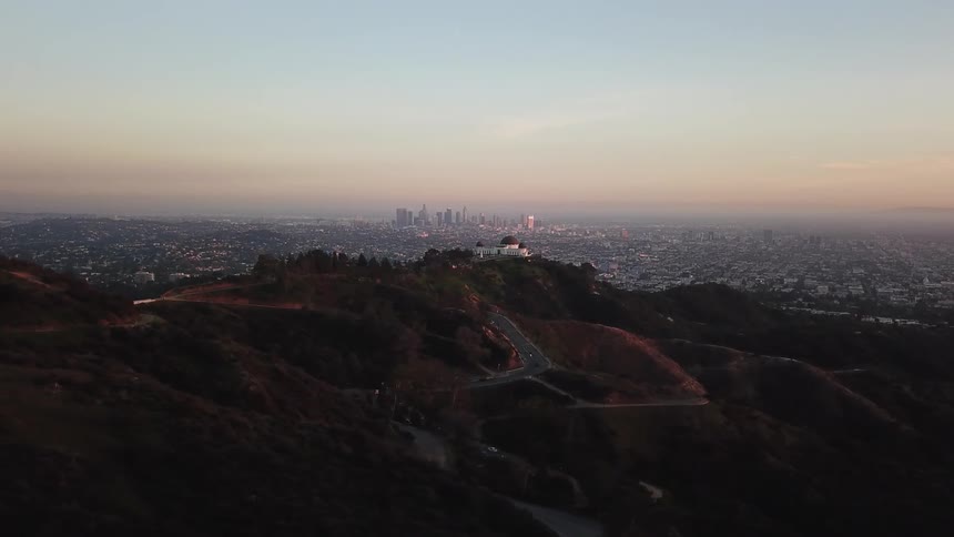 The sun sets over a city