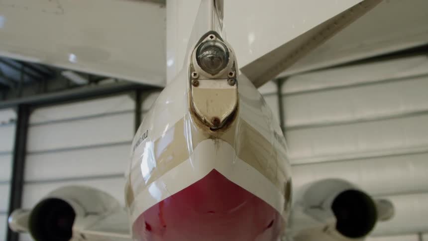 The plane with two engines is parked in the hangar