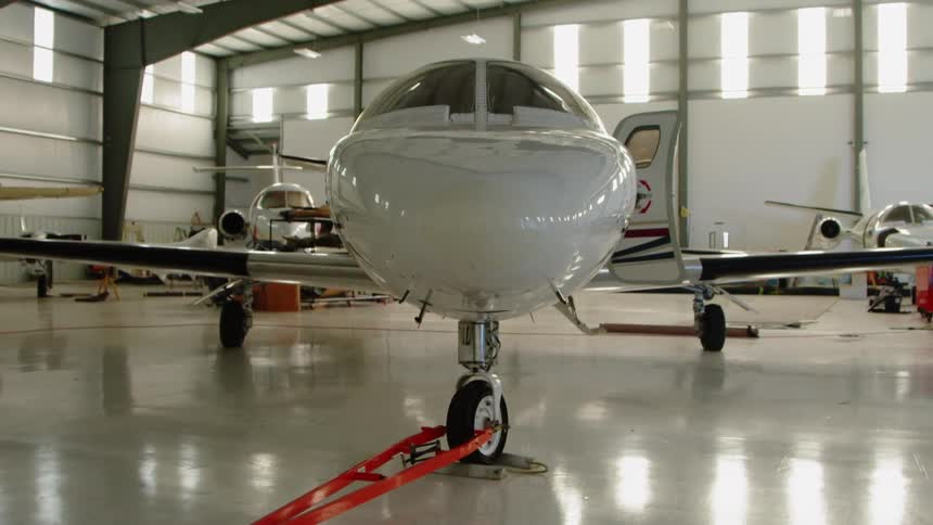 The plan sits parked in the airport hangar