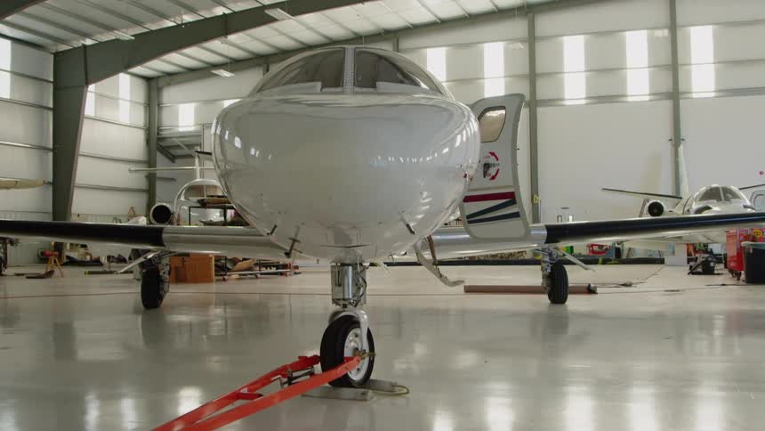 White airplane in a large airplane garage
