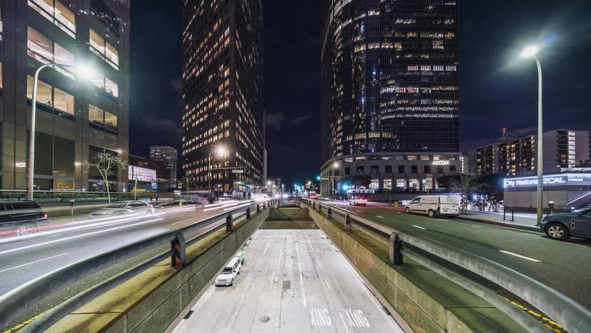 Traffic travels on a street at night