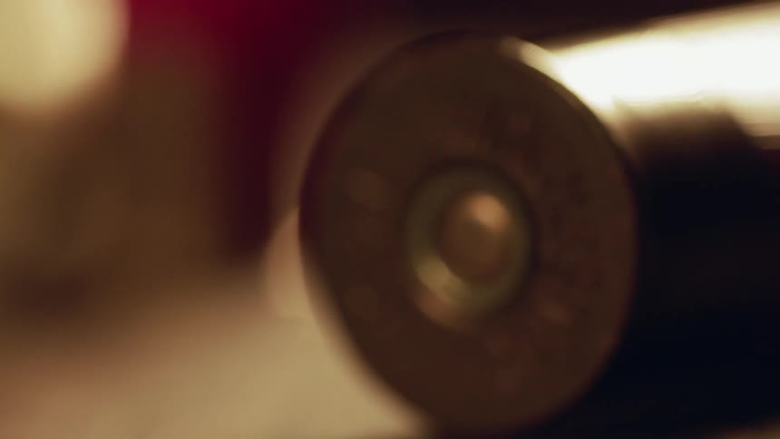 Shotgun casings are strewn across a table