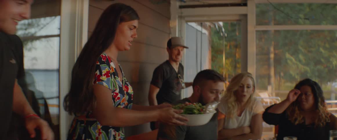 Food is being served to the table in the porch