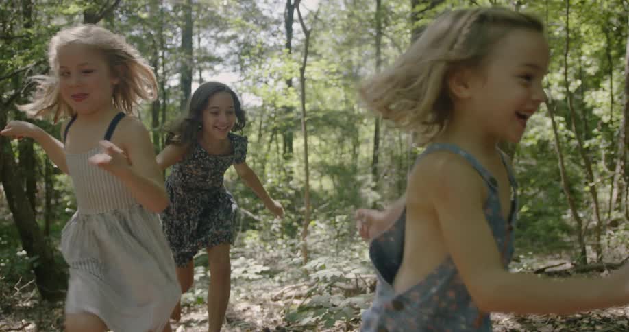 Children race in the forest together