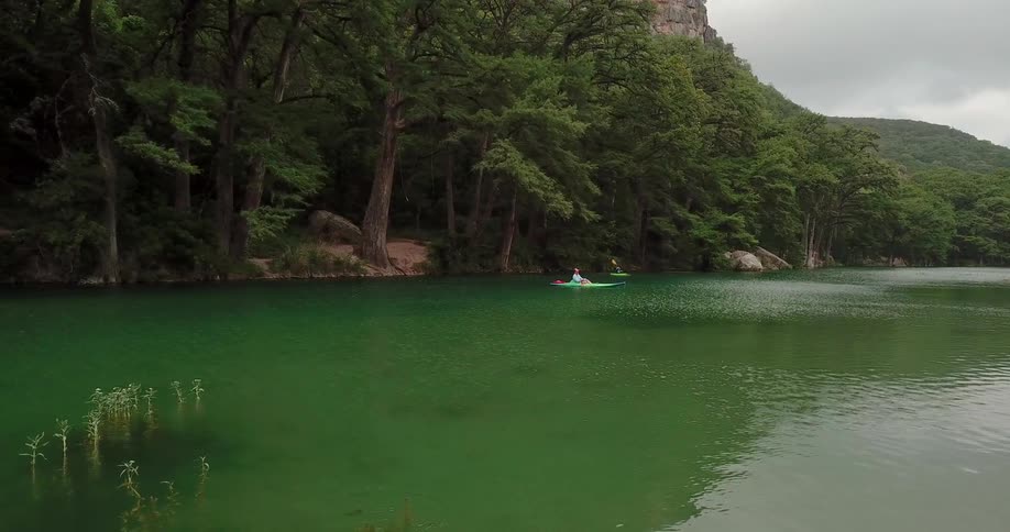 Two people kayak in the river