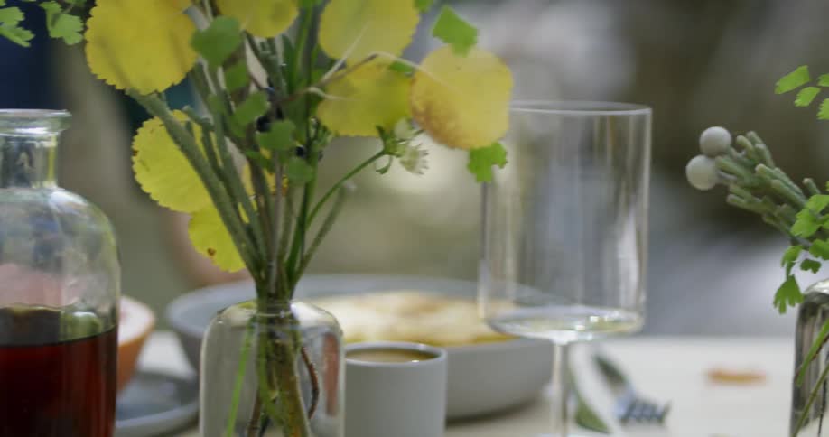 Glasses and flowers on a table outside