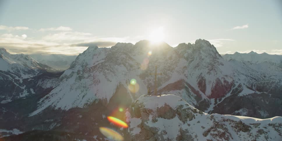 The sun is slowly rising behind the mountain range