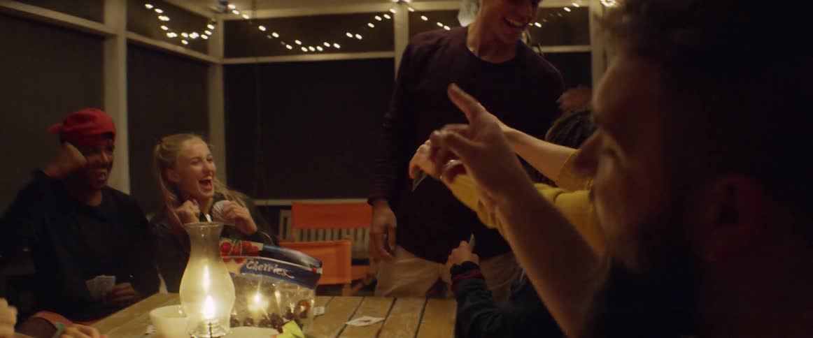 People cheer and slap their cards on the table