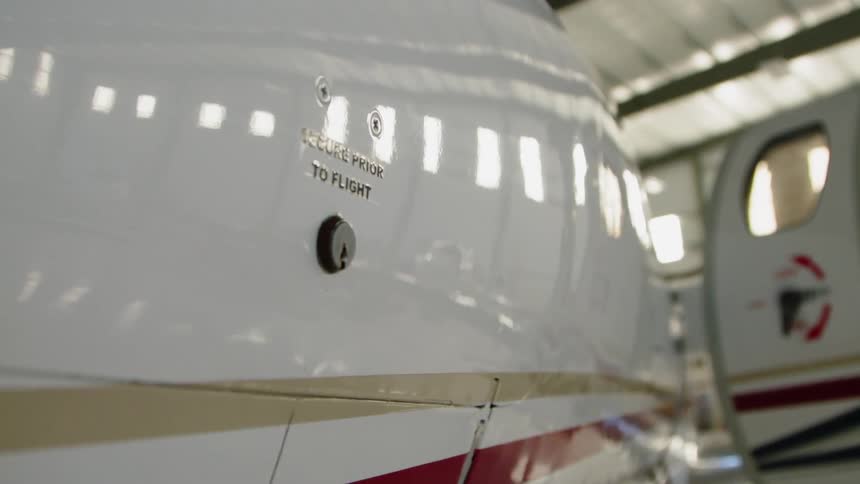 An airplane sits parked in a hangar