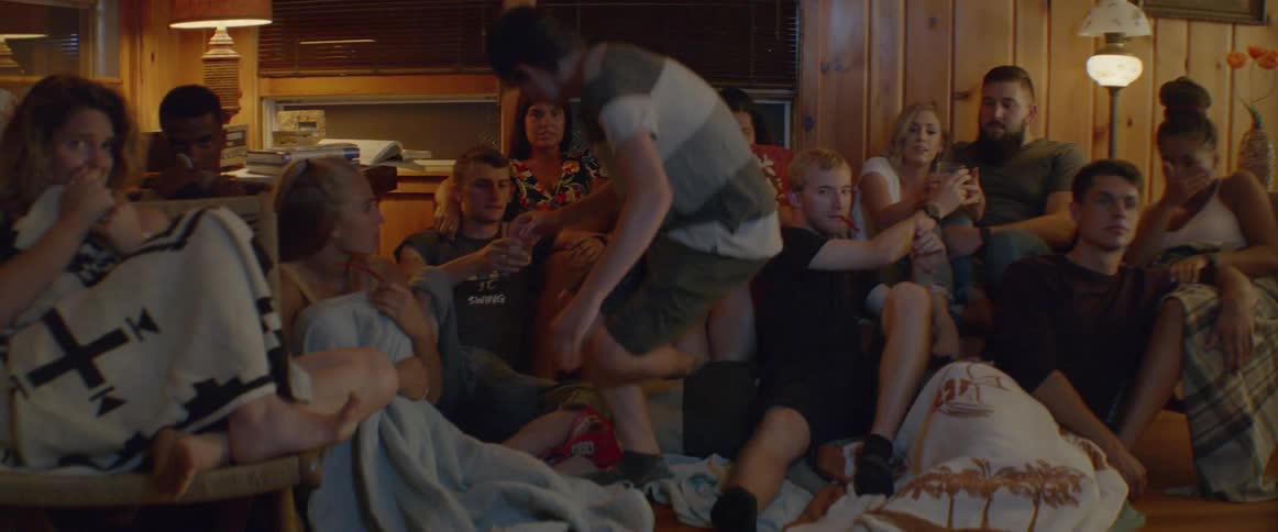 A group of people are watching a scary movie together