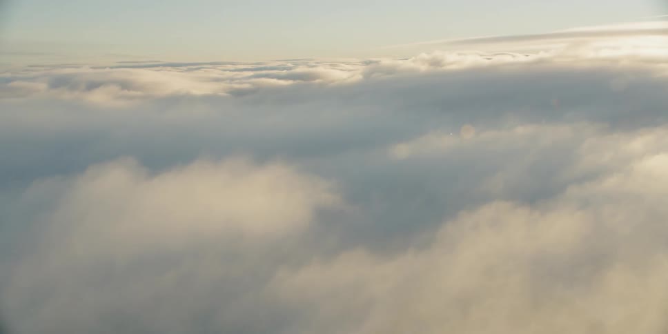 Sunlight and clear skies above a layer of clouds