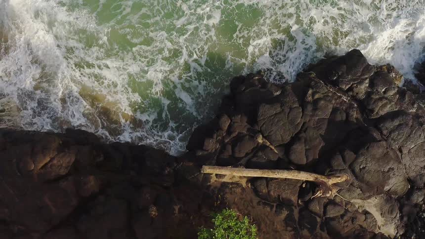 Water splashing up against rocky cliffs