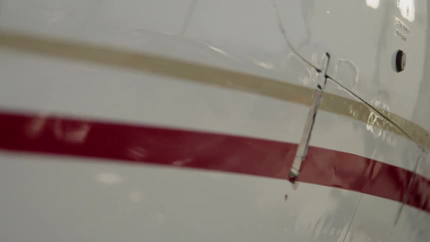 The plane is painted white with some stripes