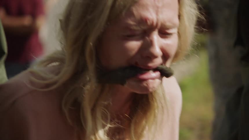 A woman cries as she is taken prisoner