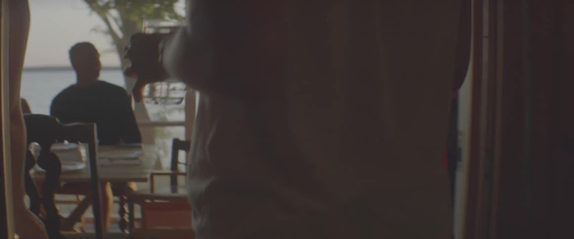 A woman serves some drinks to a table