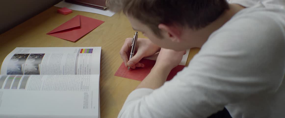 Man writes in a greeting card