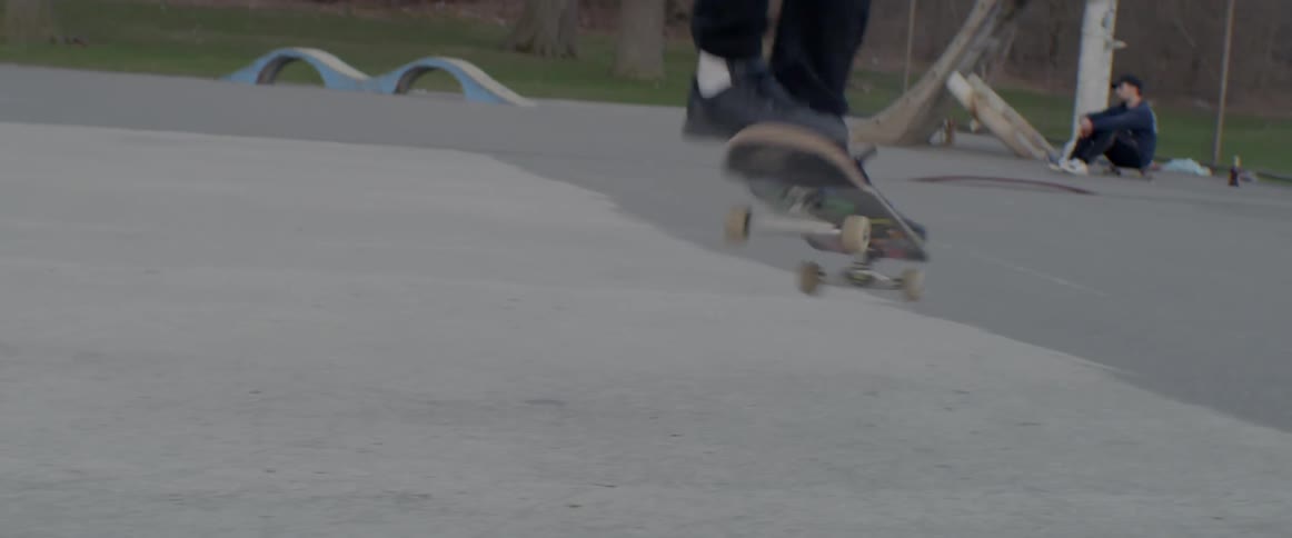 A man does a jump on his skateboard
