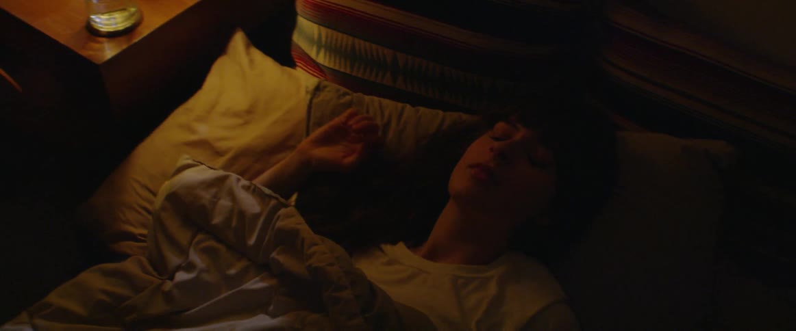 Woman wakes up and turns on a lamp