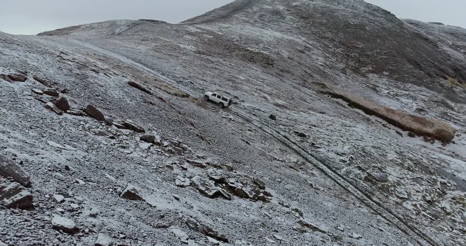 A truck climbs the ice covered hills