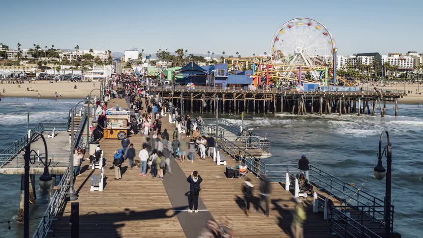 People walk on a beach pier